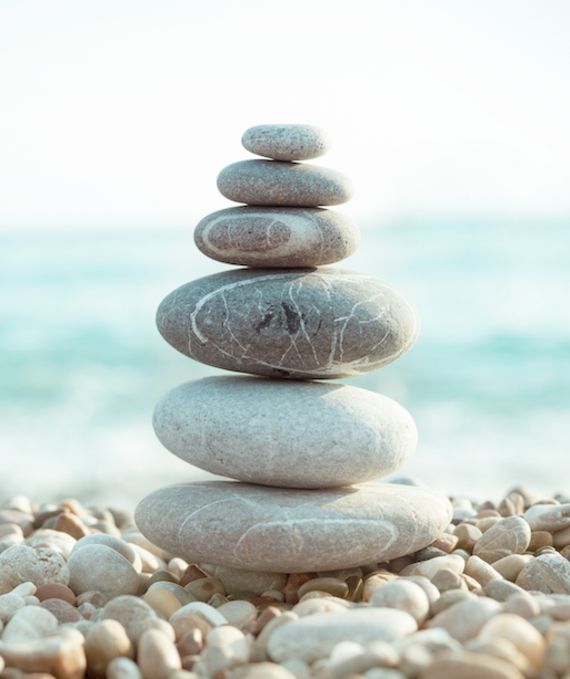 A Simple, Supportive Process: Wooden Stones Balanced on a Book